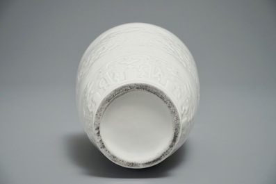 A Chinese relief-decorated blanc de Chine vase, 19/20th C.